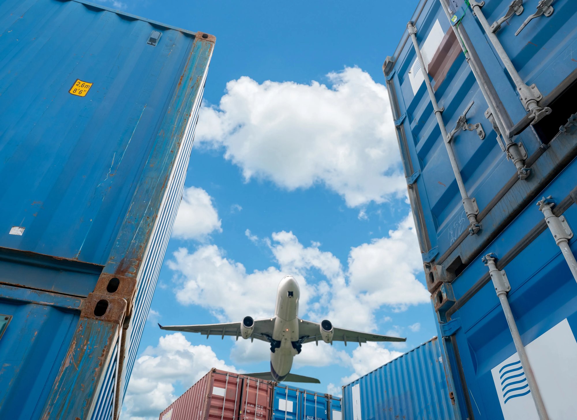 airplane-flying-above-logistic-container_cropped